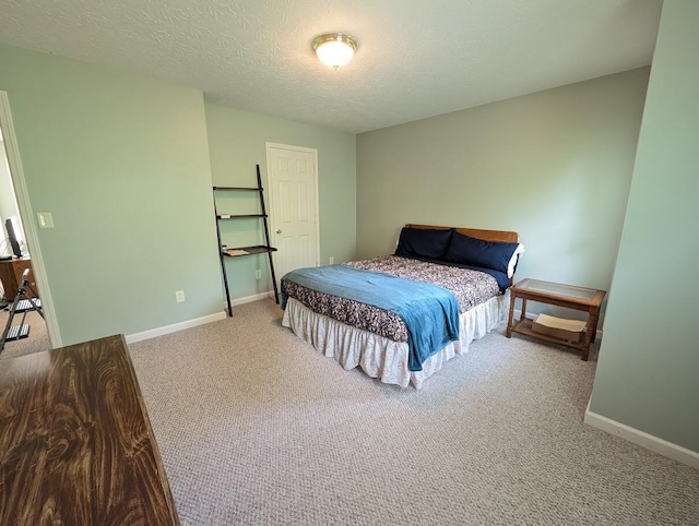 bedroom featuring baseboards, a textured ceiling, and carpet