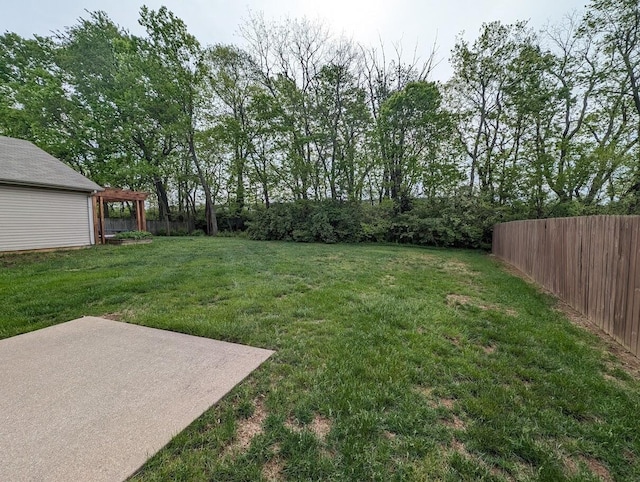 view of yard with fence, a pergola, and a patio