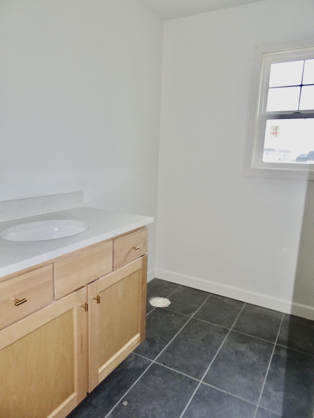 4165 Meadowlark Ln, Lexington, KY 40509 - bathroom with tile patterned floors, a sink, and baseboards
