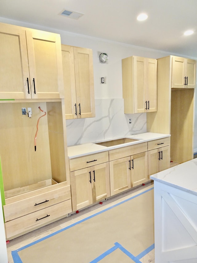 4165 Meadowlark Ln, Lexington, KY 40509 - kitchen featuring light brown cabinets, decorative backsplash, recessed lighting, and light stone countertops