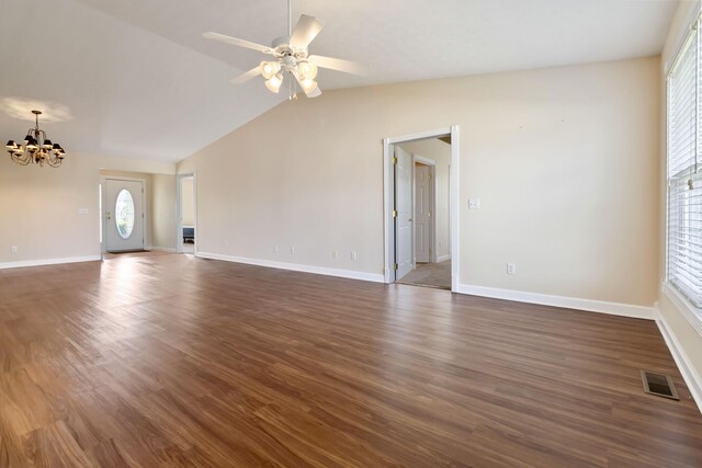 unfurnished living room with ceiling fan with notable chandelier, dark wood-style floors, lofted ceiling, and visible vents
