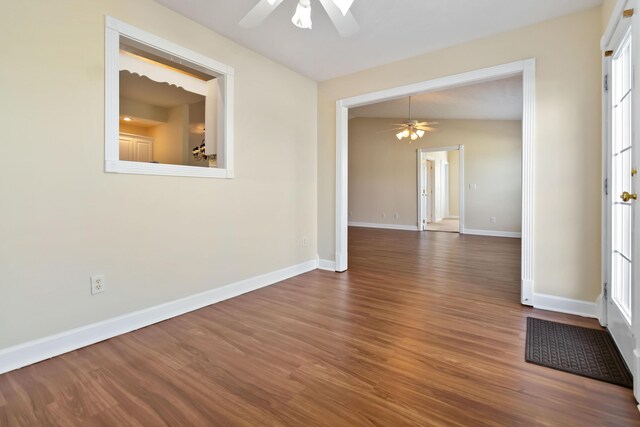 spare room with baseboards, ceiling fan, and wood finished floors