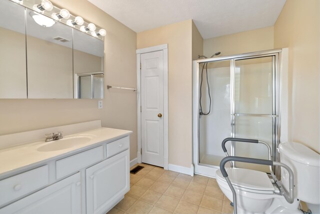 full bathroom with vanity, a shower stall, and toilet