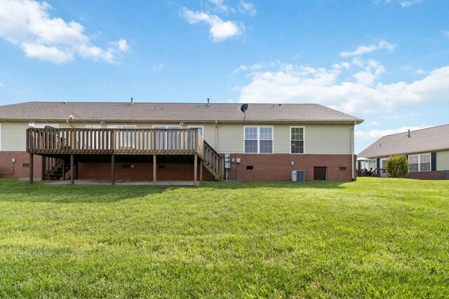 back of property featuring brick siding, a deck, stairway, cooling unit, and a yard