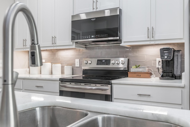 1035 Vineyard Way, Berea, KY 40403 - kitchen featuring appliances with stainless steel finishes, white cabinetry, and backsplash
