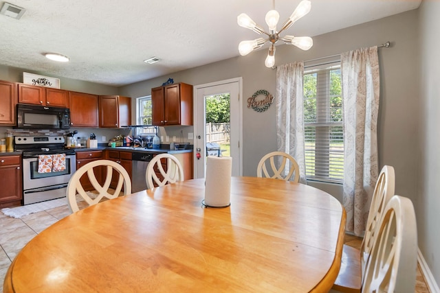 dining room with an inviting chandelier, visible vents, and a healthy amount of sunlight