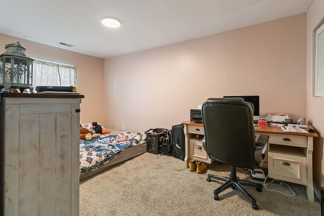 carpeted bedroom featuring visible vents
