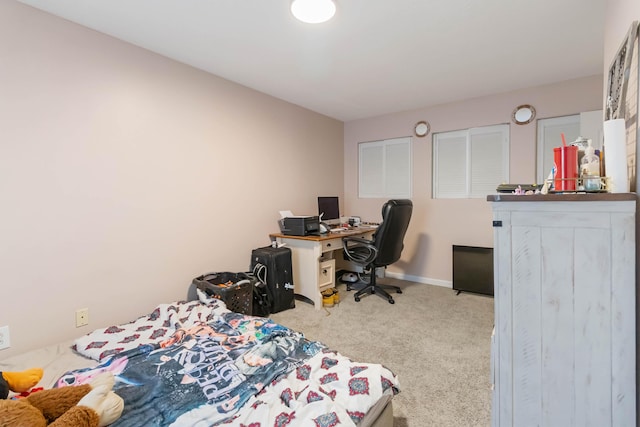bedroom with baseboards and carpet
