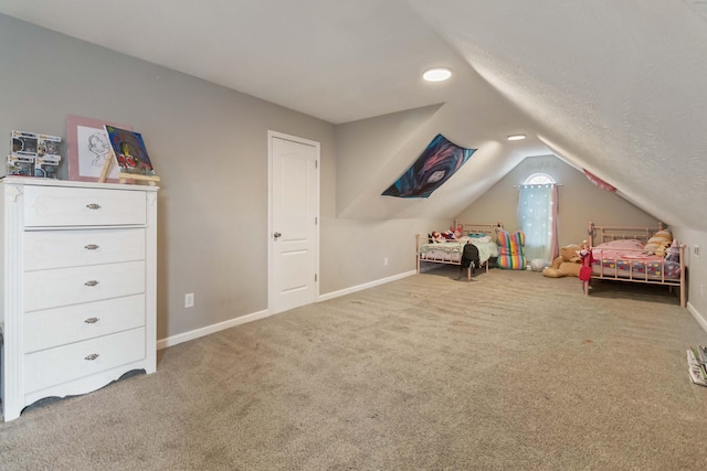 carpeted bedroom featuring baseboards and lofted ceiling