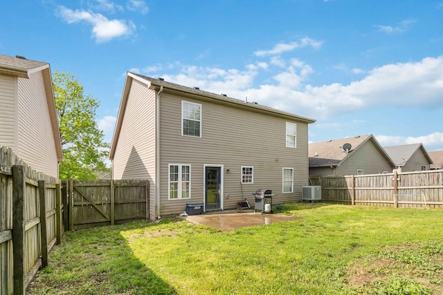 rear view of house with a patio, a fenced backyard, central AC unit, a gate, and a lawn