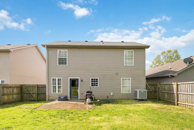 rear view of house with a fenced backyard, a yard, cooling unit, and a patio area