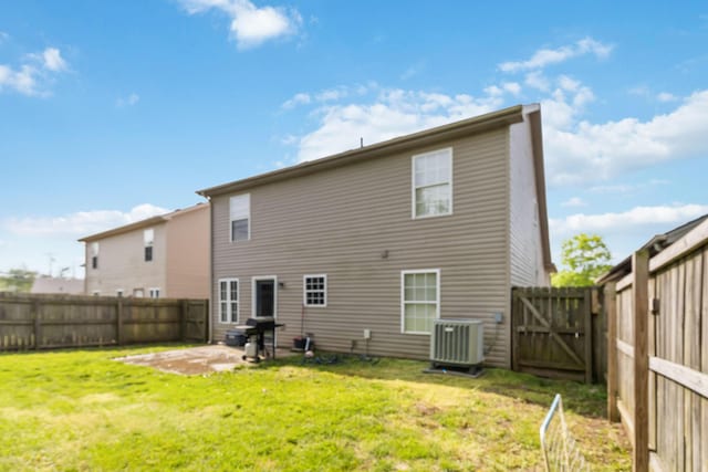 rear view of house featuring cooling unit, a fenced backyard, a gate, a patio area, and a lawn