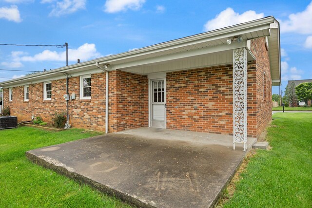 136 Pin Oak Dr, Lancaster, KY 40444 - back of house featuring a yard, central AC unit, a patio, and brick siding