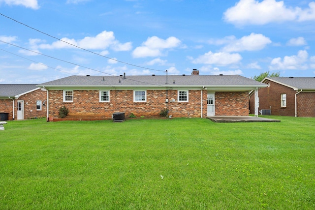 136 Pin Oak Dr, Lancaster, KY 40444 - back of property with brick siding, a patio, a chimney, and a lawn