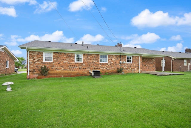 136 Pin Oak Dr, Lancaster, KY 40444 - rear view of house featuring a yard, a patio, brick siding, and central AC unit