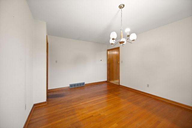 136 Pin Oak Dr, Lancaster, KY 40444 - unfurnished room featuring baseboards, a notable chandelier, light wood finished floors, and visible vents