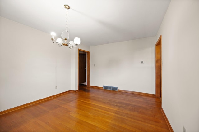 136 Pin Oak Dr, Lancaster, KY 40444 - spare room featuring an inviting chandelier, wood finished floors, visible vents, and baseboards