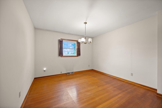 136 Pin Oak Dr, Lancaster, KY 40444 - unfurnished room with an inviting chandelier, light wood finished floors, baseboards, and visible vents
