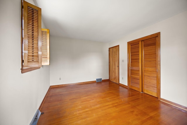 136 Pin Oak Dr, Lancaster, KY 40444 - unfurnished bedroom with visible vents, wood finished floors, baseboards, and multiple closets