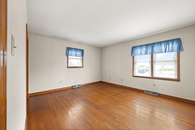 136 Pin Oak Dr, Lancaster, KY 40444 - spare room featuring baseboards, visible vents, and wood finished floors