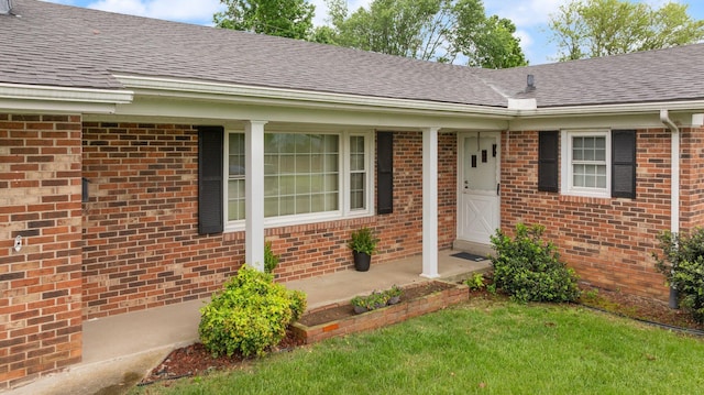 136 Pin Oak Dr, Lancaster, KY 40444 - view of exterior entry with a lawn, brick siding, and roof with shingles