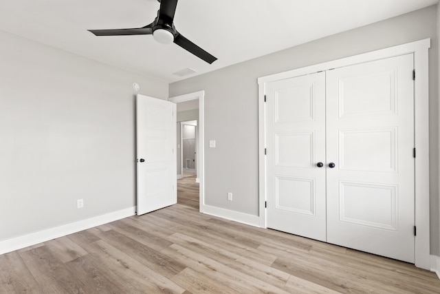 unfurnished bedroom with a ceiling fan, visible vents, baseboards, a closet, and light wood finished floors