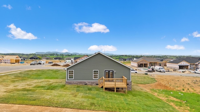 back of house with a residential view, a mountain view, a lawn, and crawl space