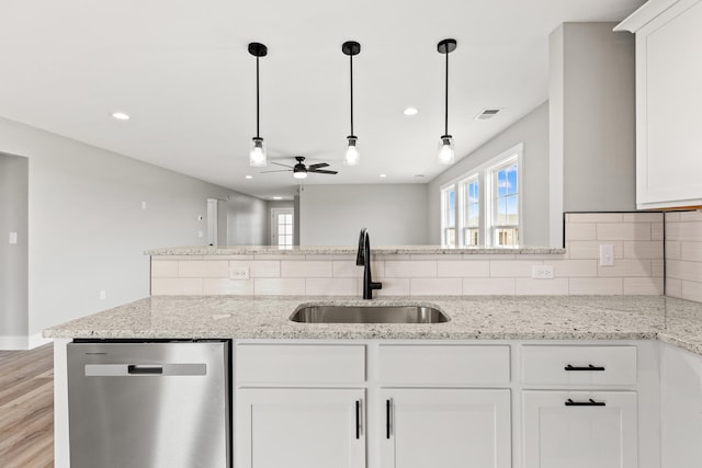 kitchen with stainless steel dishwasher, decorative backsplash, a ceiling fan, visible vents, and a sink