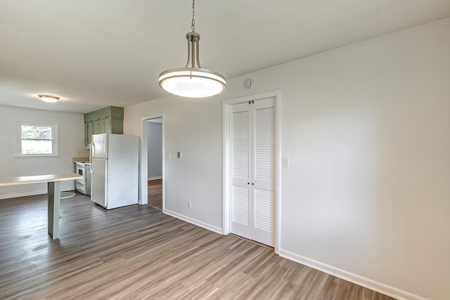 114 Cave Springs Dr, Lancaster, KY 40444 - unfurnished dining area with baseboards and dark wood-type flooring