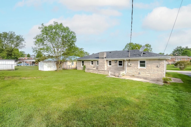 114 Cave Springs Dr, Lancaster, KY 40444 - rear view of property featuring stone siding, a patio, a lawn, a storage shed, and an outbuilding