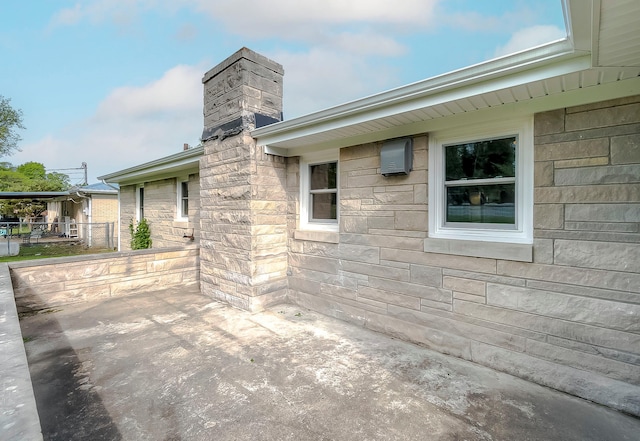 114 Cave Springs Dr, Lancaster, KY 40444 - view of property exterior featuring fence, a patio, a chimney, and stone siding