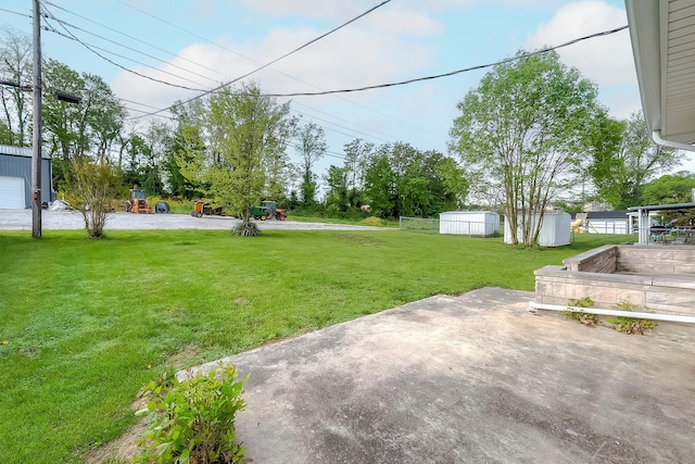 114 Cave Springs Dr, Lancaster, KY 40444 - view of yard featuring a storage unit, an outdoor structure, and a patio