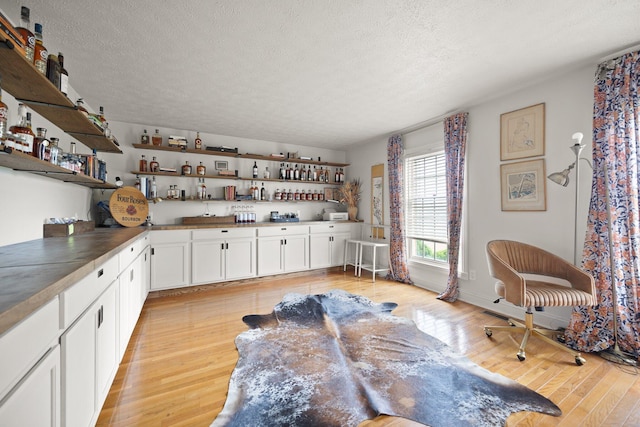 500 Curdsville Rd, Harrodsburg, KY 40330 - kitchen featuring a textured ceiling, open shelves, light wood-style flooring, and white cabinets