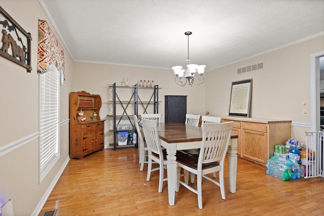 500 Curdsville Rd, Harrodsburg, KY 40330 - dining area featuring a chandelier, light wood-style floors, visible vents, and ornamental molding