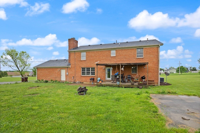 500 Curdsville Rd, Harrodsburg, KY 40330 - rear view of property featuring a patio, a fire pit, a chimney, a lawn, and brick siding