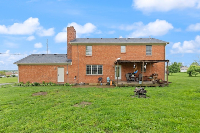 500 Curdsville Rd, Harrodsburg, KY 40330 - rear view of house with a chimney, a patio, brick siding, and a lawn