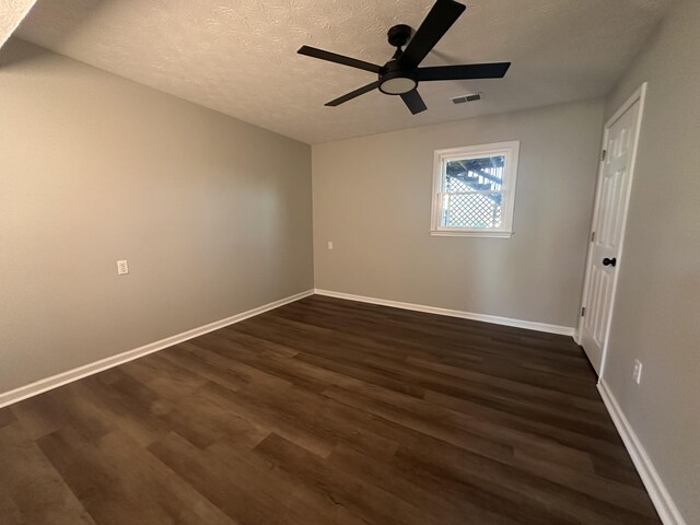 1072 Jenny Lilllard Rd, Lawrenceburg, KY 40342 - spare room with a textured ceiling, visible vents, baseboards, and dark wood-type flooring
