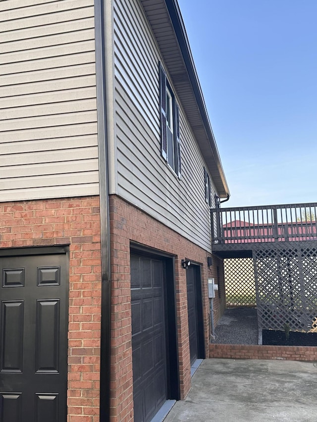 1072 Jenny Lilllard Rd, Lawrenceburg, KY 40342 - view of side of home featuring a garage, a wooden deck, and brick siding