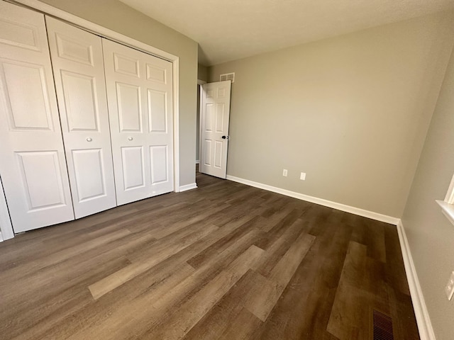 1072 Jenny Lilllard Rd, Lawrenceburg, KY 40342 - unfurnished bedroom with baseboards, a closet, dark wood-style floors, and visible vents