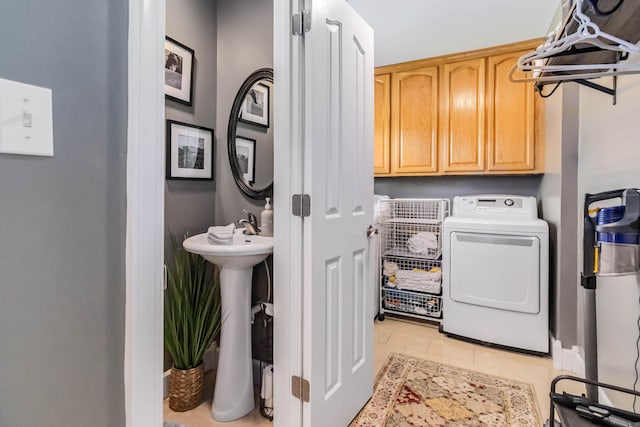 laundry area with a sink, washer / clothes dryer, and cabinet space