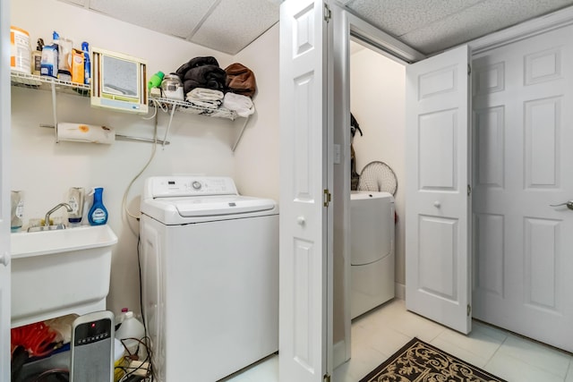 laundry room with washer / clothes dryer, light tile patterned flooring, and laundry area