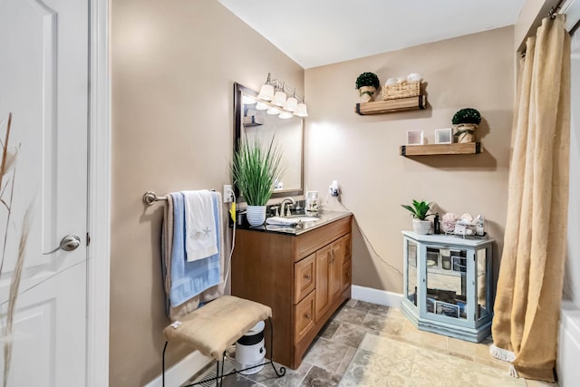 bathroom featuring baseboards and vanity