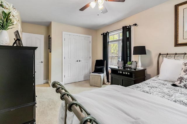 bedroom with ceiling fan, carpet floors, and a closet
