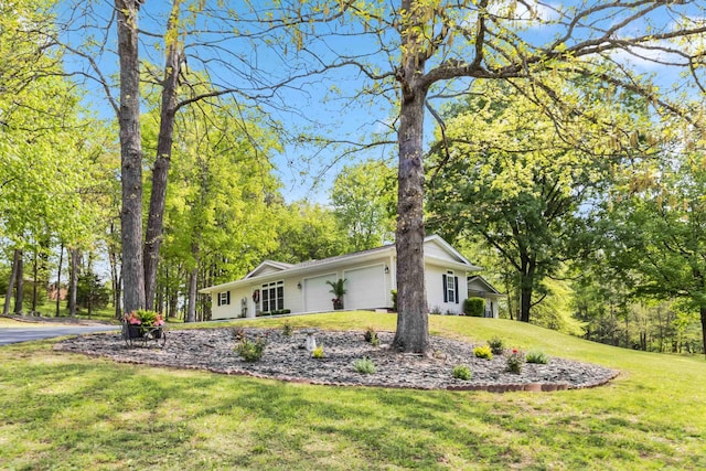 view of home's exterior with an attached garage and a lawn