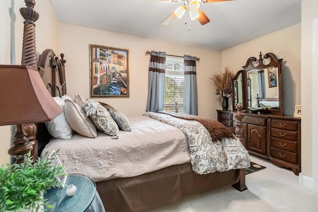 bedroom featuring light colored carpet and a ceiling fan