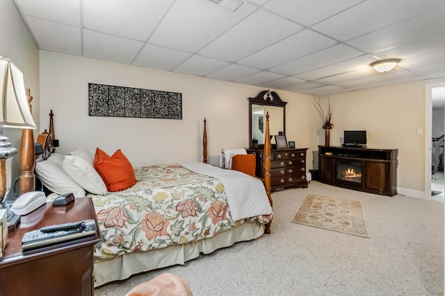 bedroom featuring a paneled ceiling, visible vents, and carpet floors