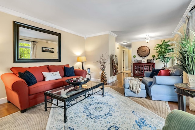 living area featuring baseboards, crown molding, and wood finished floors