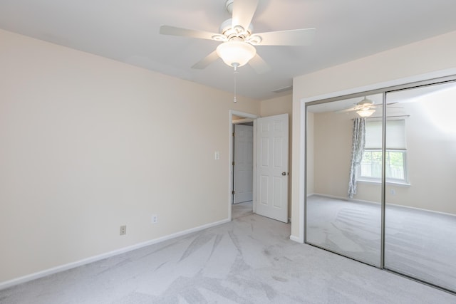 unfurnished bedroom featuring baseboards, ceiling fan, carpet, and a closet