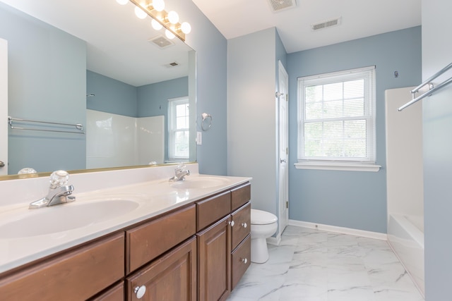 bathroom with a sink, toilet, marble finish floor, and visible vents