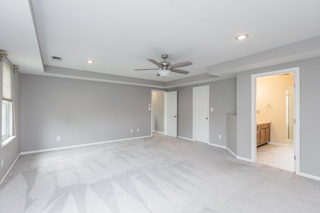 unfurnished bedroom with visible vents, a raised ceiling, baseboards, light carpet, and recessed lighting